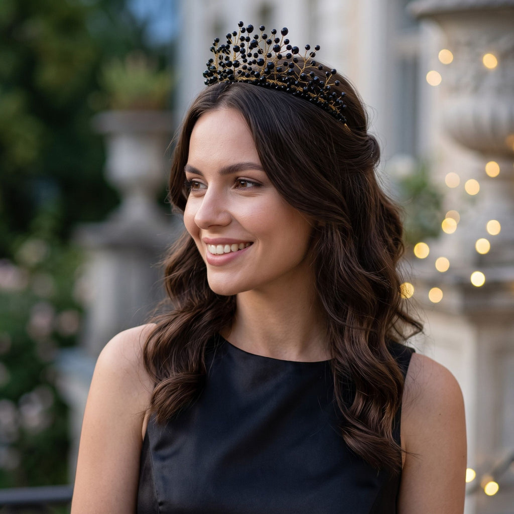 Smiling woman wearing the handmade Black Majesty crown with black faceted beads and gold wire branches, styled with a black dress outdoors.