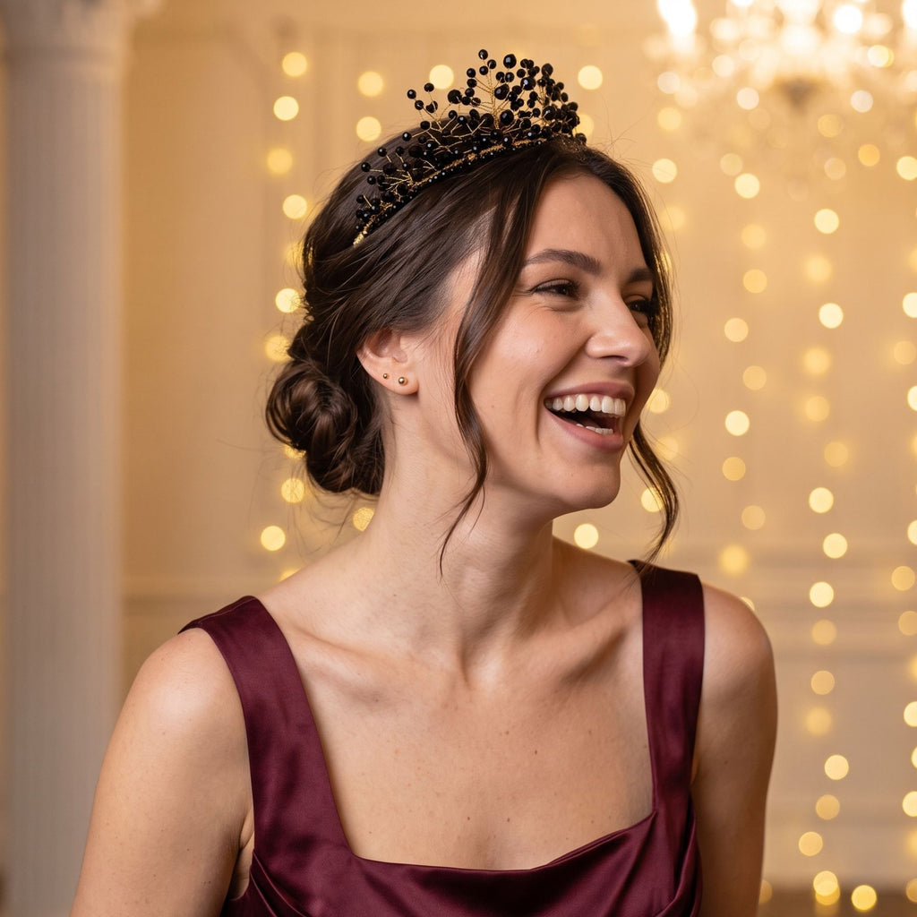 Laughing woman wearing the handmade Black Majesty crown with black faceted beads and gold wire branches, styled with an elegant burgundy dress.