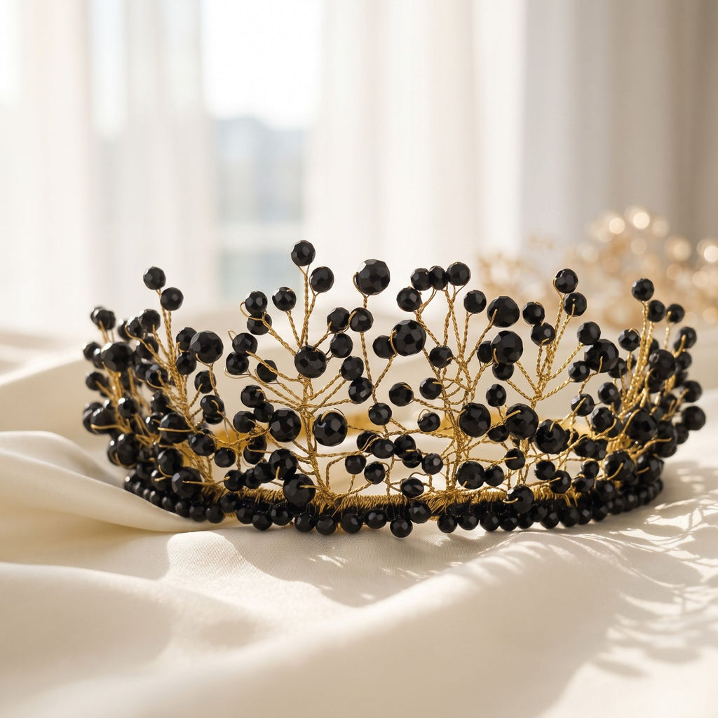 Handmade Black Majesty crown with faceted black beads and gold wire branches, displayed on soft ivory satin fabric.