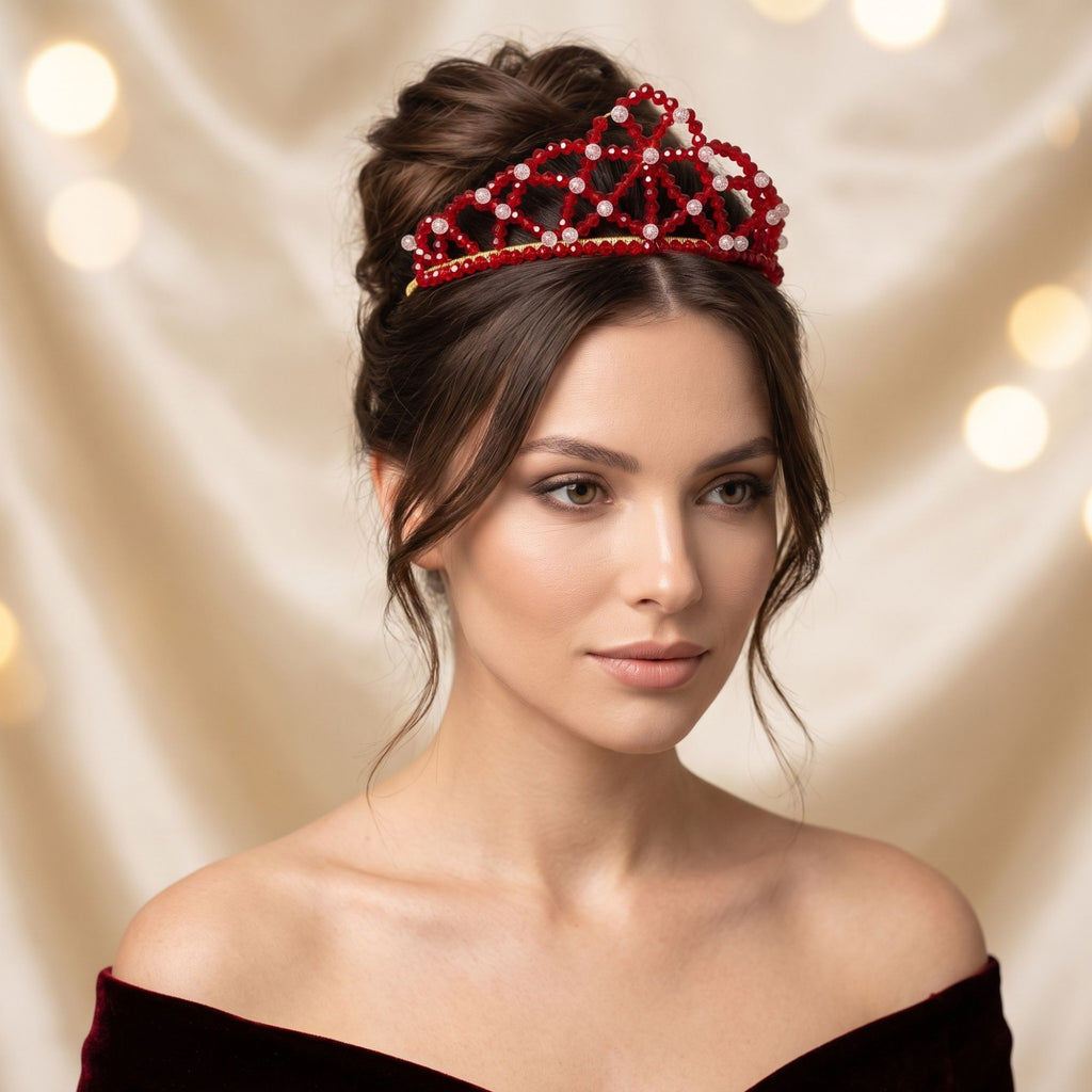 Elegant woman wearing the handmade Red Queen crown with faceted red glass beads, clear accent beads and gold-tone details, styled with an elegant updo.